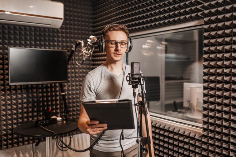 Person recording voiceover in soundproof booth
