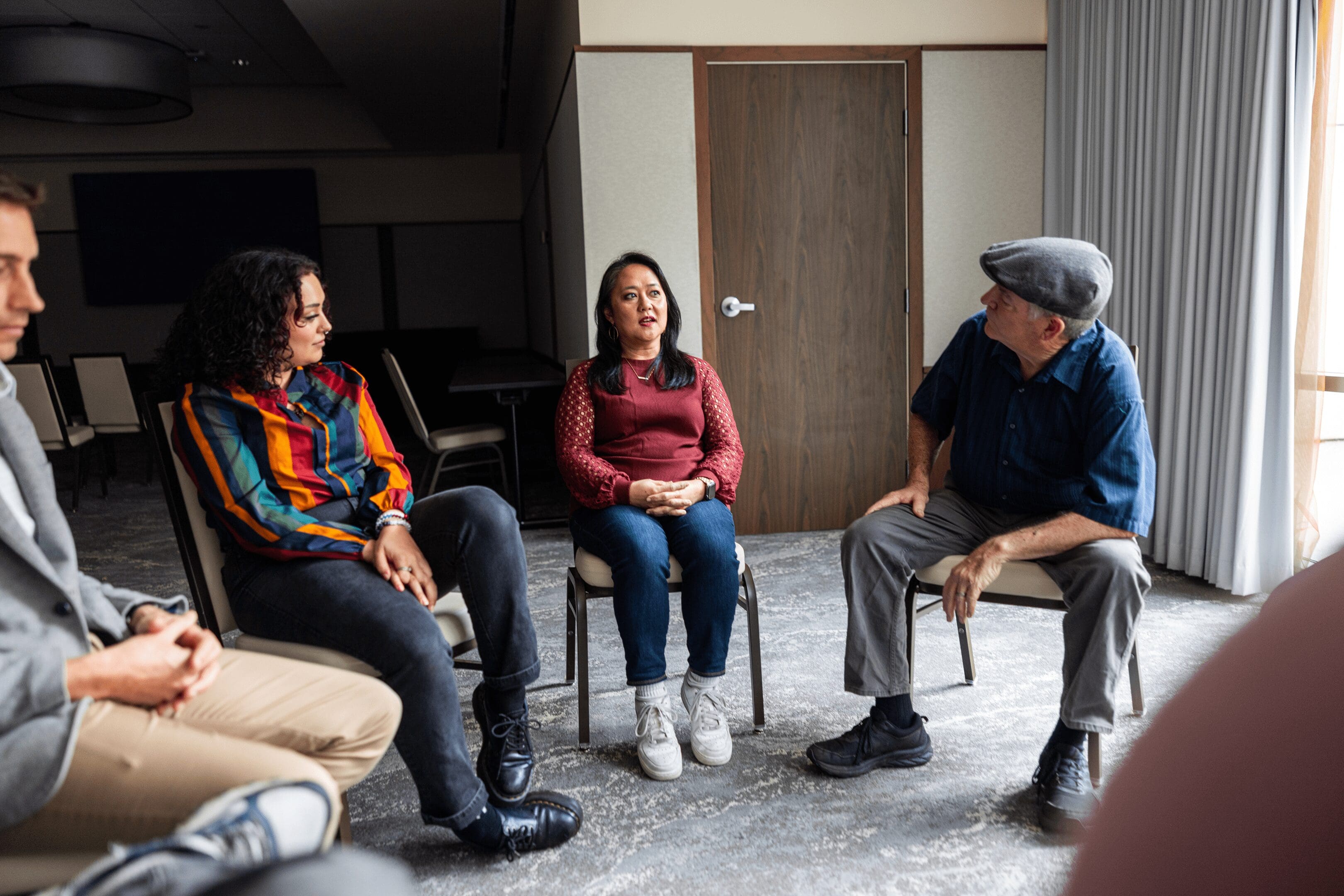 People seated in a group therapy circle