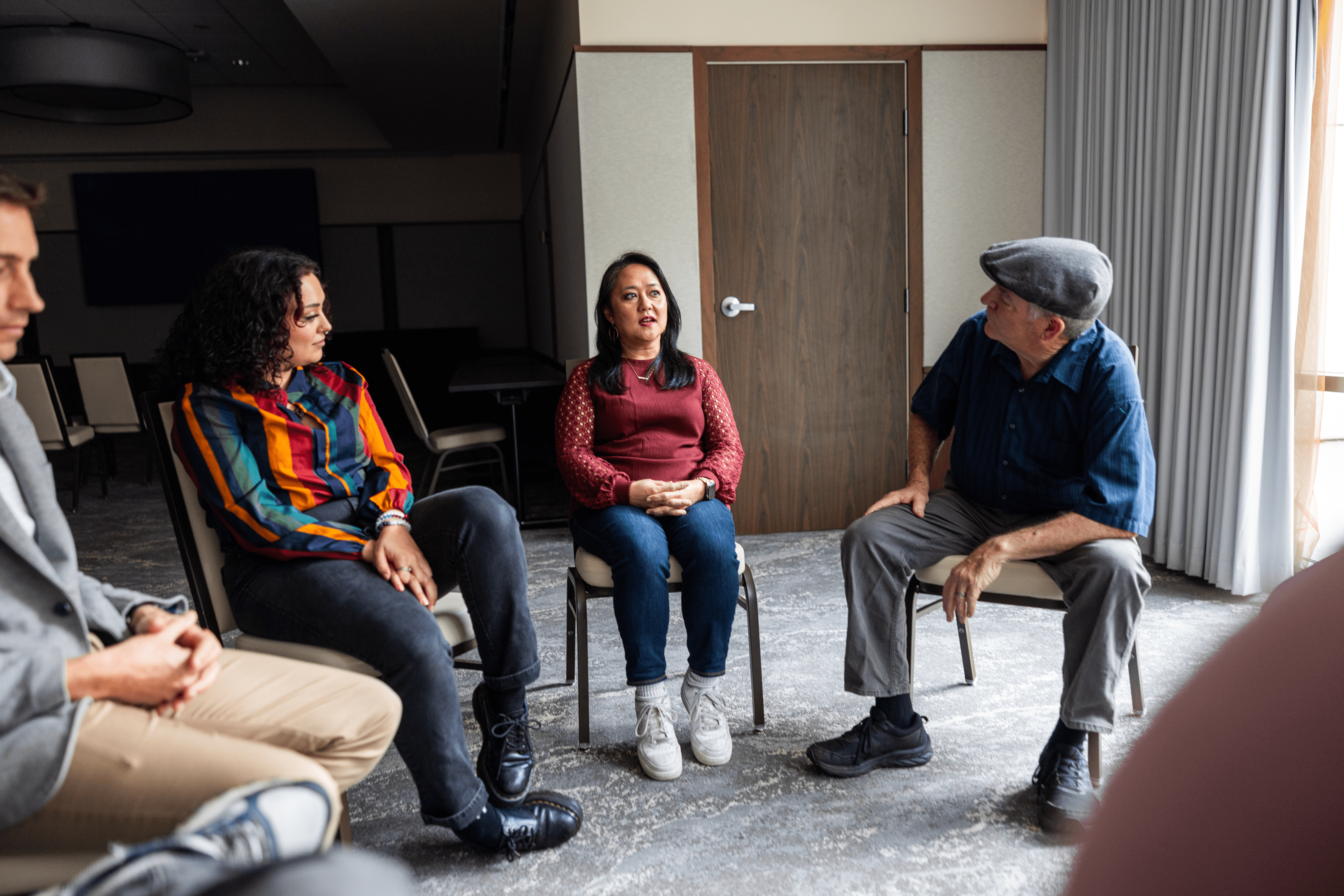 People seated in a group therapy circle
