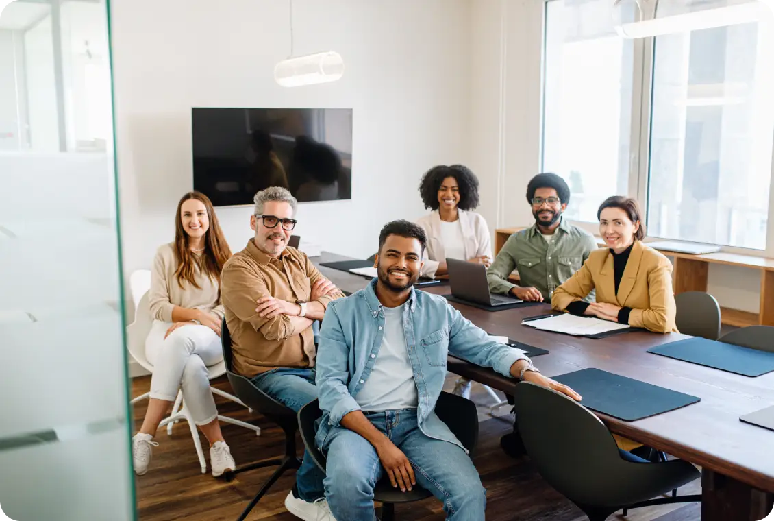 Diverse team smiling in modern conference room