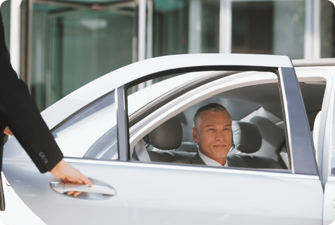 Man in suit sitting in car backseat